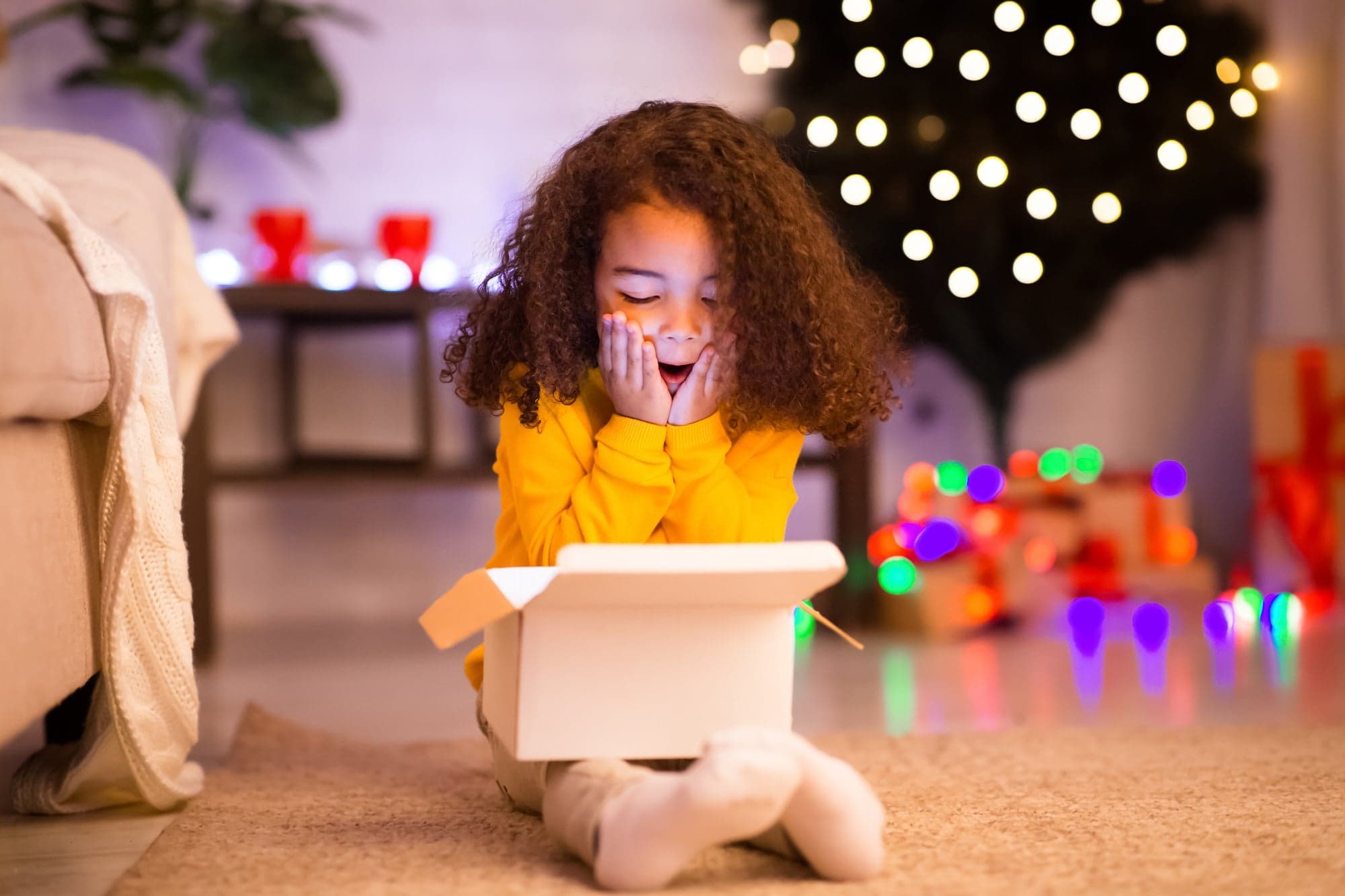Young girl surprised opening a gift box